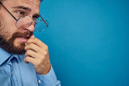 business man with glasses emotions blue backgroundの写真素材