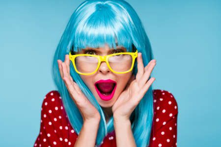 glamorous woman in blue wig yellow glasses posing modelの写真素材