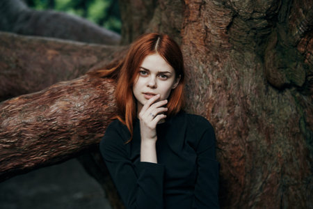 woman in black dress nature walk garden trees fresh airの写真素材