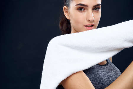 cheerful sports woman slim figure white towel in her handsの写真素材