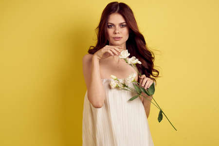 pretty woman flowers in hands posing charm lifestyle glamorの写真素材