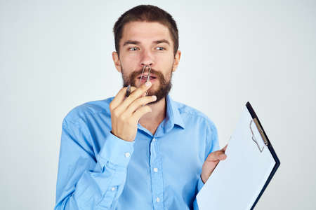 bearded man in blue shirt documents manager professionalの写真素材