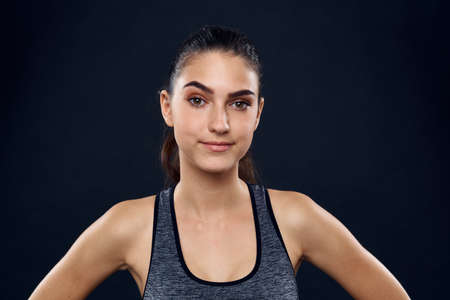 athletic woman exercise workout slim figure dark backgroundの写真素材