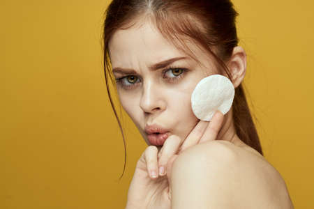 emotional women bare shoulders cotton pads and clear skin attractive lookの写真素材