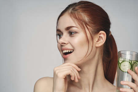 woman with cucumber drink health vitamins close-upの写真素材