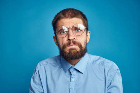 business man with glasses emotions blue backgroundの写真素材