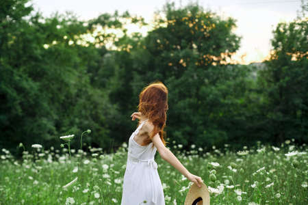 pretty woman in a field in nature white dress fresh airの写真素材