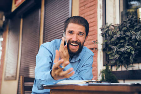 bearded man with laptop in cafe workingの写真素材