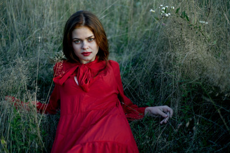 woman lies on the grass in a red dress landscape fashion