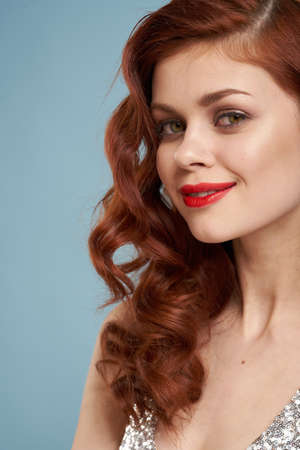 attractive red-haired woman red lips face close upの写真素材