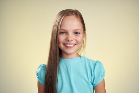 cheerful little girl with long hair close-up studio posingの写真素材