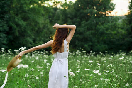 pretty woman in a field in nature white dress fresh airの写真素材
