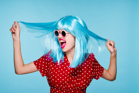 emotional glamorous woman on blue wig fashion glasses posing
