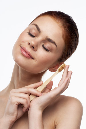 cheerful woman with bare shoulders toothbrushes hygiene oral care