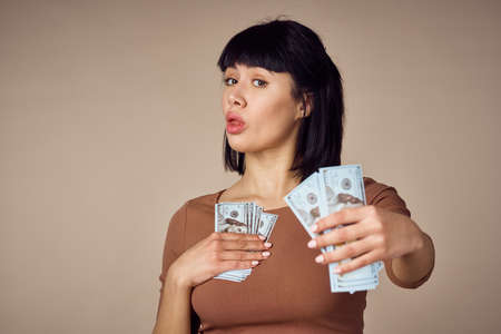 emotional woman with money in hands finance positiveの写真素材