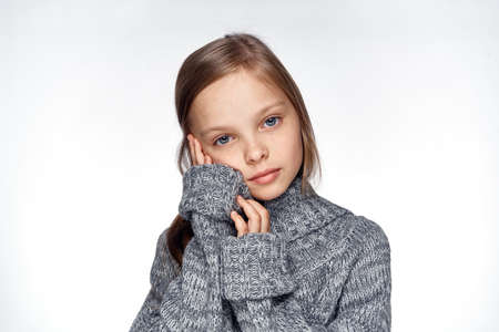 girl in sweater temperature health problems light backgroundの写真素材