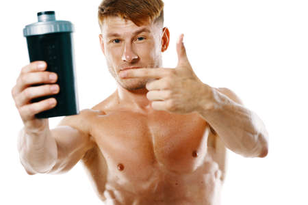 athletic man with a pumped-up torso drink bottle sportspitの写真素材