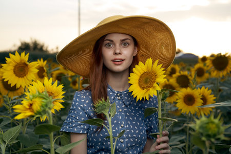 pretty woman with hat in the field of sunflowers freedom nature