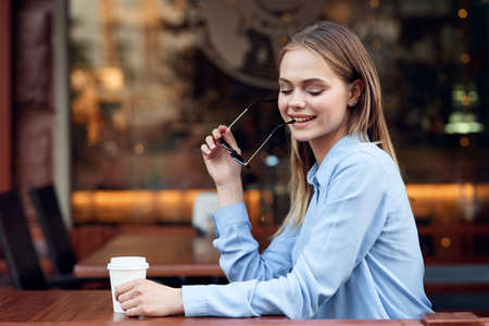 Business woman in a cafe in the summer outdoors on vacationの写真素材
