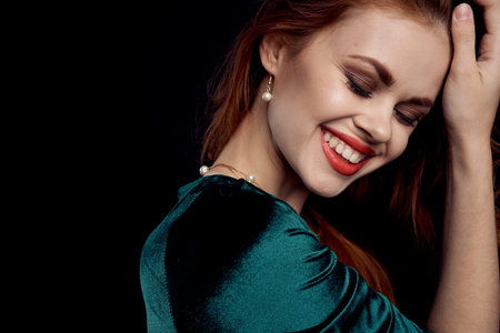 attractive woman green dress red lips charm Black backgroundの写真素材
