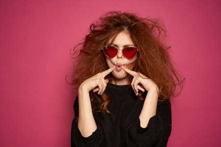 pretty woman charm cosmetics posing smile pink backgroundの写真素材