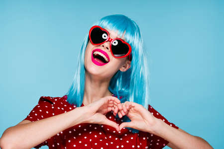 emotional woman blue wig sunglasses posing fashionの写真素材