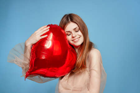 cheerful woman red heart in the hands of the balloon model studioの写真素材