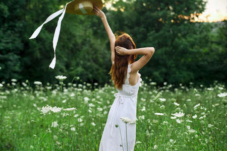 pretty woman in a field in nature white dress fresh airの写真素材