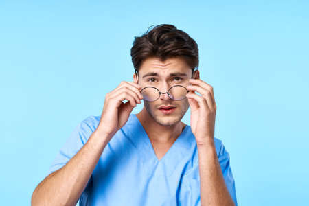 man in medical uniform health care treatment examination blue backgroundの写真素材