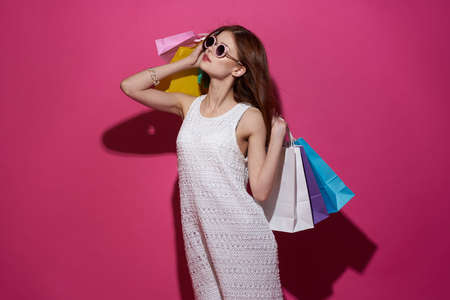 pretty woman with packages in hands Shopaholic isolated backgroundの写真素材