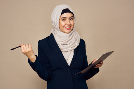 muslim woman with documents in hands office work businessの写真素材