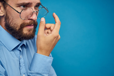 business man with glasses emotions blue backgroundの写真素材