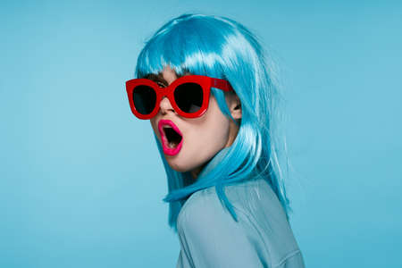 attractive woman in purple wig red glasses posing close-upの写真素材