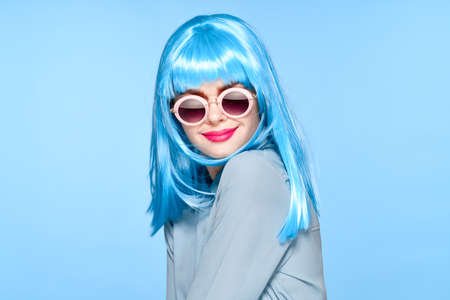 cheerful woman wearing sunglasses blue wig glamor modelの写真素材
