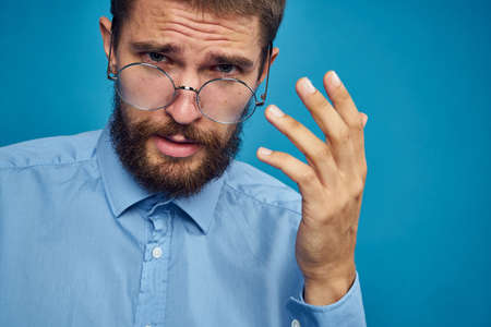 business man with glasses emotions blue backgroundの写真素材