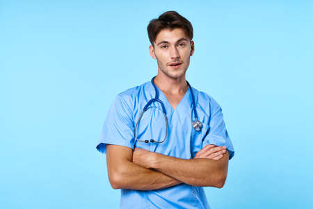 man in medical uniform patient treatment hospital medicine blue backgroundの写真素材
