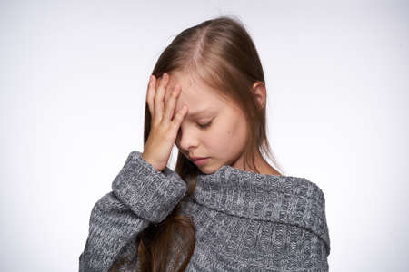 girl in sweater temperature health problems light backgroundの写真素材