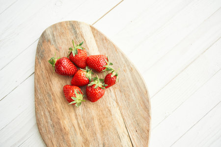 fresh strawberries on wooden board fruit vitamins summerの写真素材