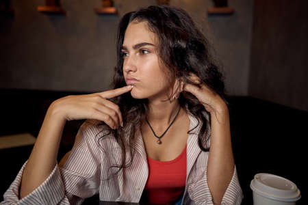 woman in restaurant sits by the table morning rest breakfastの写真素材