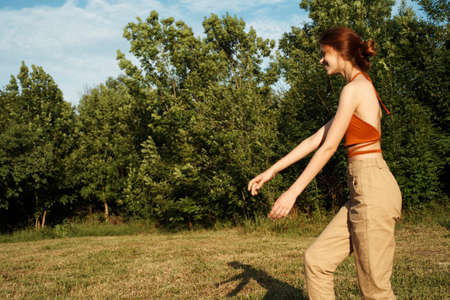woman playing with a big black dog outdoors in the field fun friendshipの写真素材