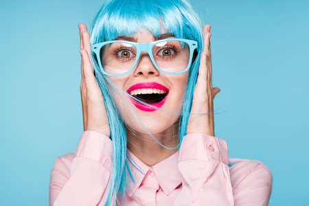 pretty woman in pink shirt purple wig glasses red lipsの写真素材