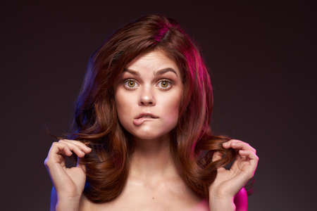 beautiful woman attractive look bare shoulders charm dark backgroundの写真素材