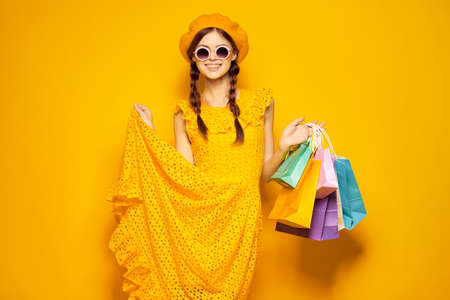 pretty woman wearing sunglasses posing shopping fashion isolated backgroundの写真素材