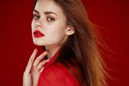 woman with red hair fashion posing red shirt glamorの写真素材