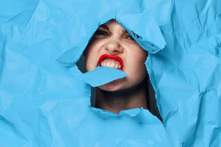 female face blue background red lips makeup emotionsの写真素材