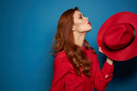 pretty woman attractive look posing red hat isolated backgroundの写真素材