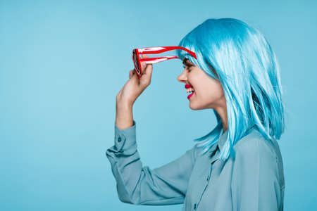 attractive woman in purple wig red glasses posing close-upの写真素材