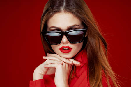 glamorous woman wearing sunglasses red shirt hairstyle modelの写真素材