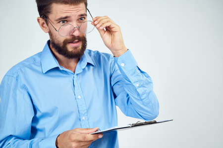 bearded man in blue shirt documents manager professionalの写真素材