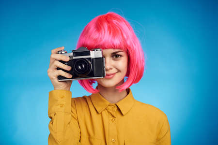 pretty woman with pink hair photographer with camera creative professionの写真素材